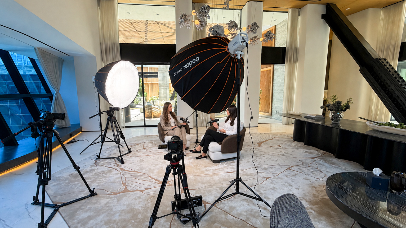Mobile podcast production setup with cinema cameras, lighting and two hosts in Dubai